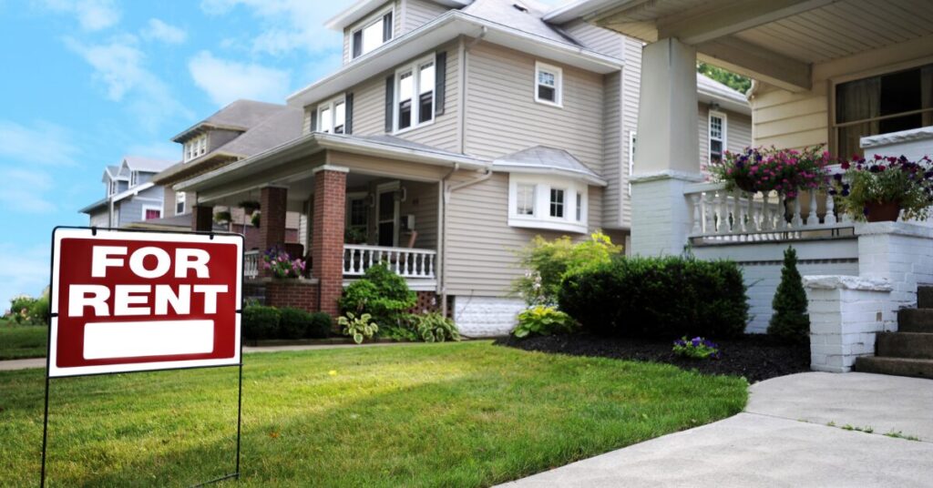 Single-family home with a For Rent sign, representing a short-term rental property used in real estate tax strategies.